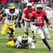 Ohio State quarterback Braxton Miller evades Michigan tackles in the second half on Saturday. Daniel Brenner I AnnArbor.com